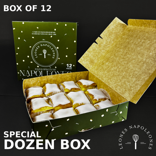 Open box of Leonés Napoleones with a green lid and gold interior, featuring the brand logo.