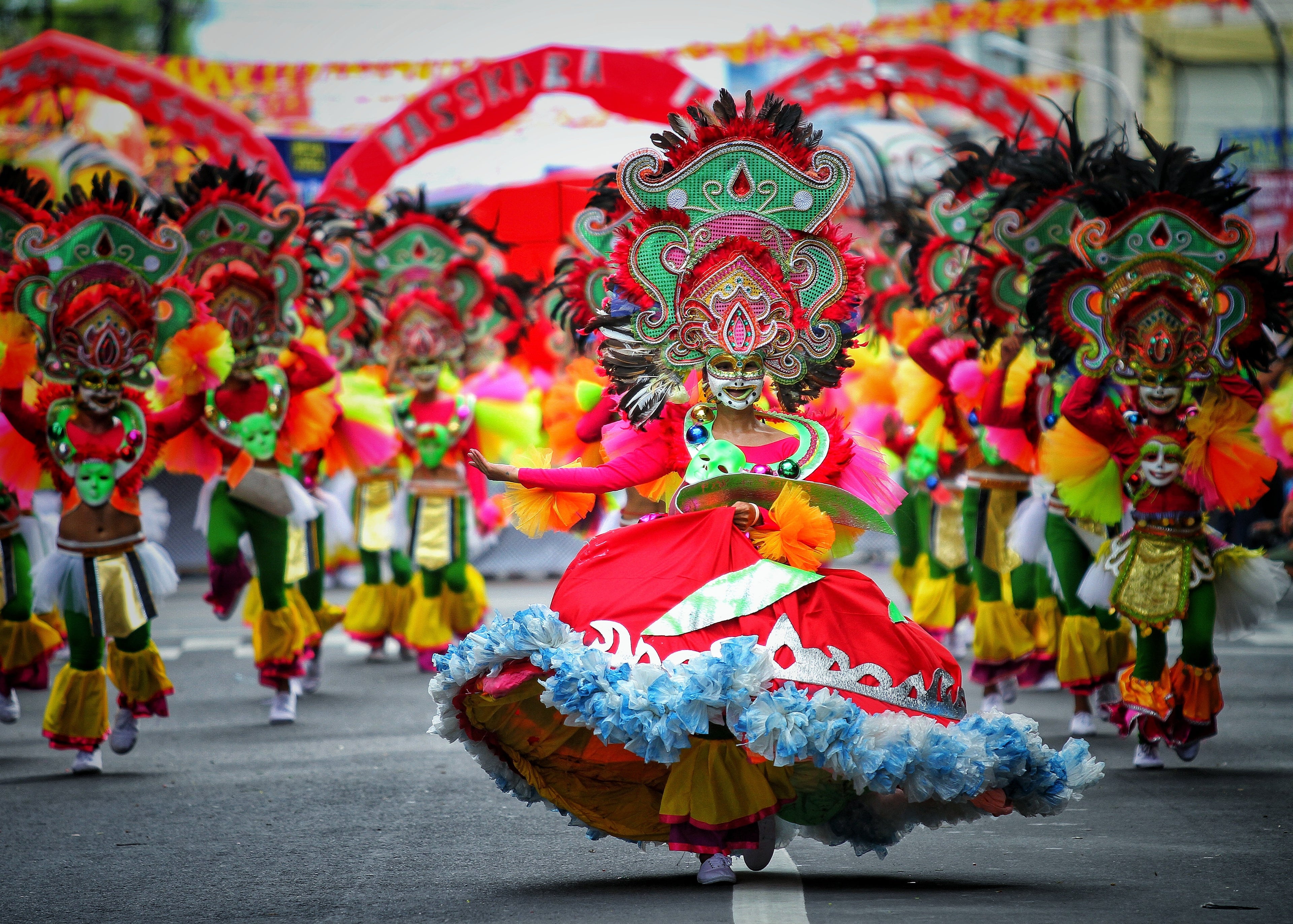 MassKara Festival queen wearing a colourful smiling mask and costume