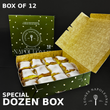 Open box of Leonés Napoleones with a green lid and gold interior, featuring the brand logo.